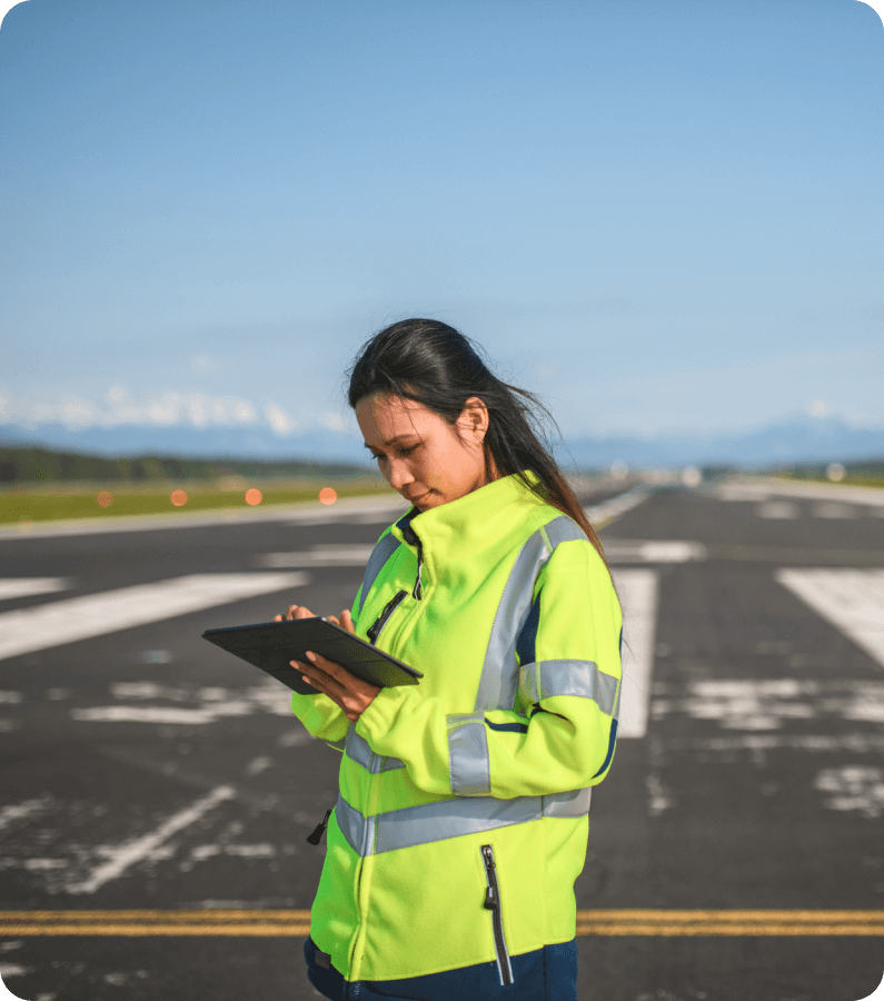 a woman using a tablet on a runway