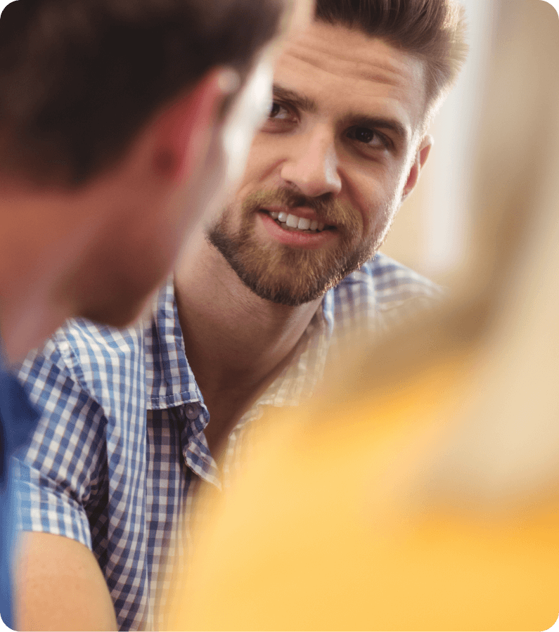 man smiling during a conversation