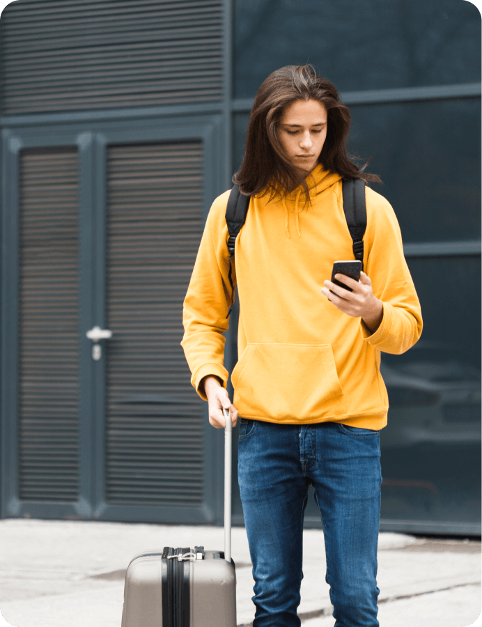 a person with yellow jacket looking at a phone