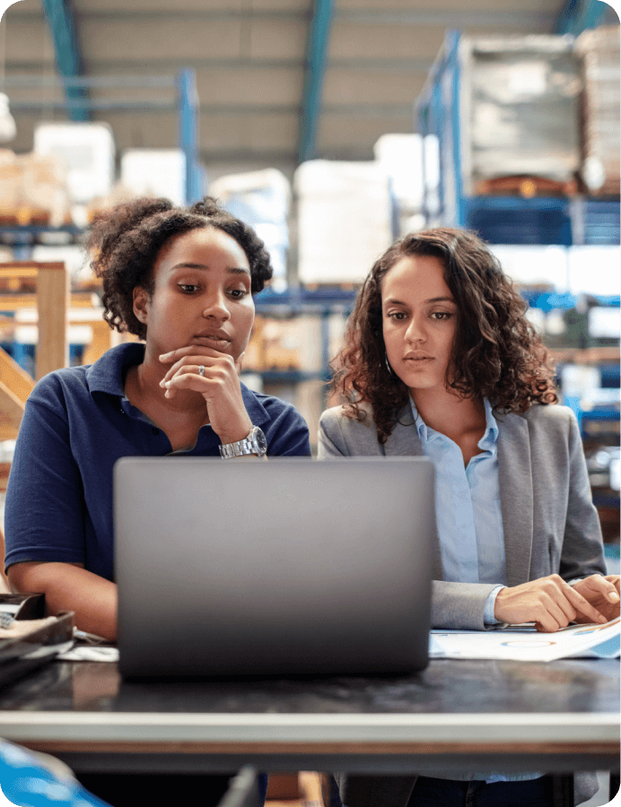 two women looking at the screen of the laptop