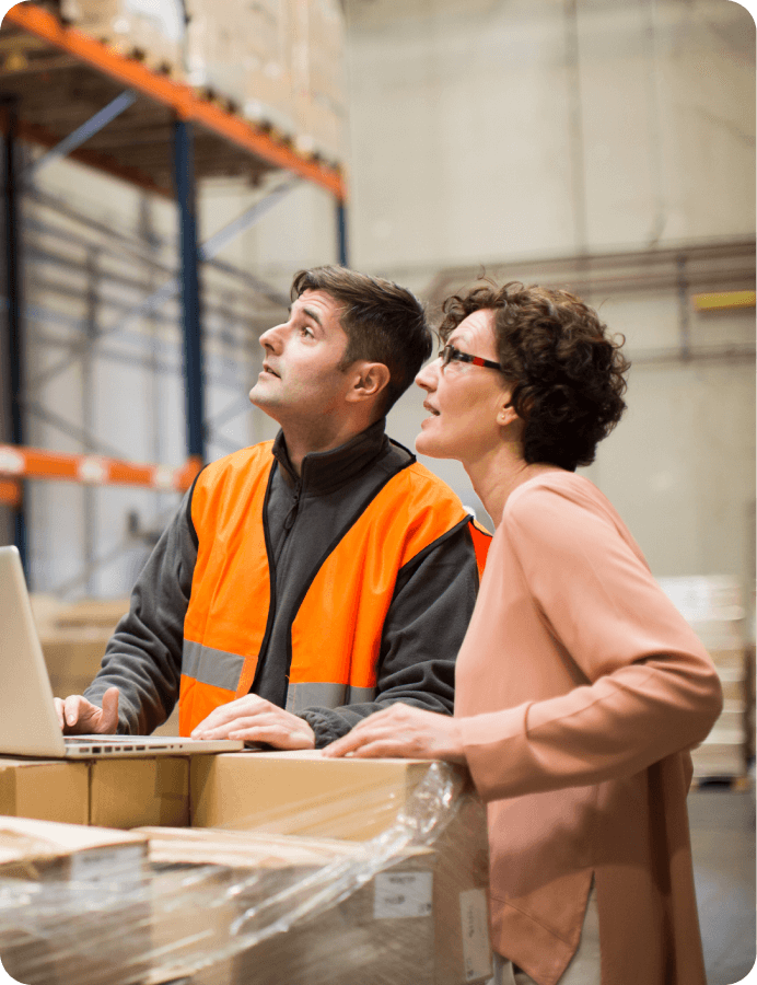 a man and a woman looking at something on a construction site